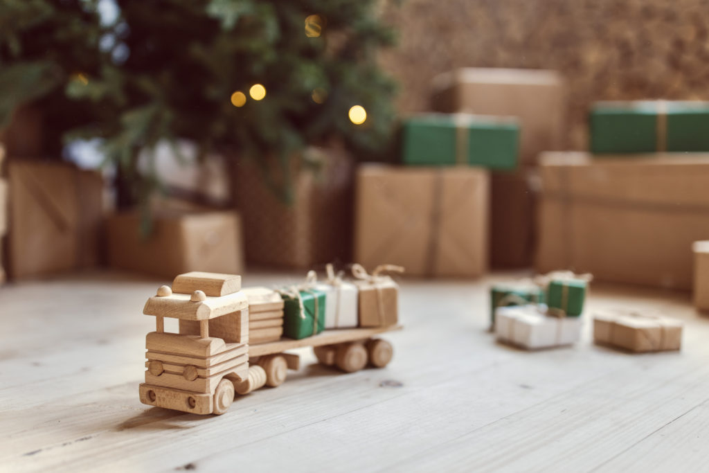 Wooden toy car with christmas gift boxes on top